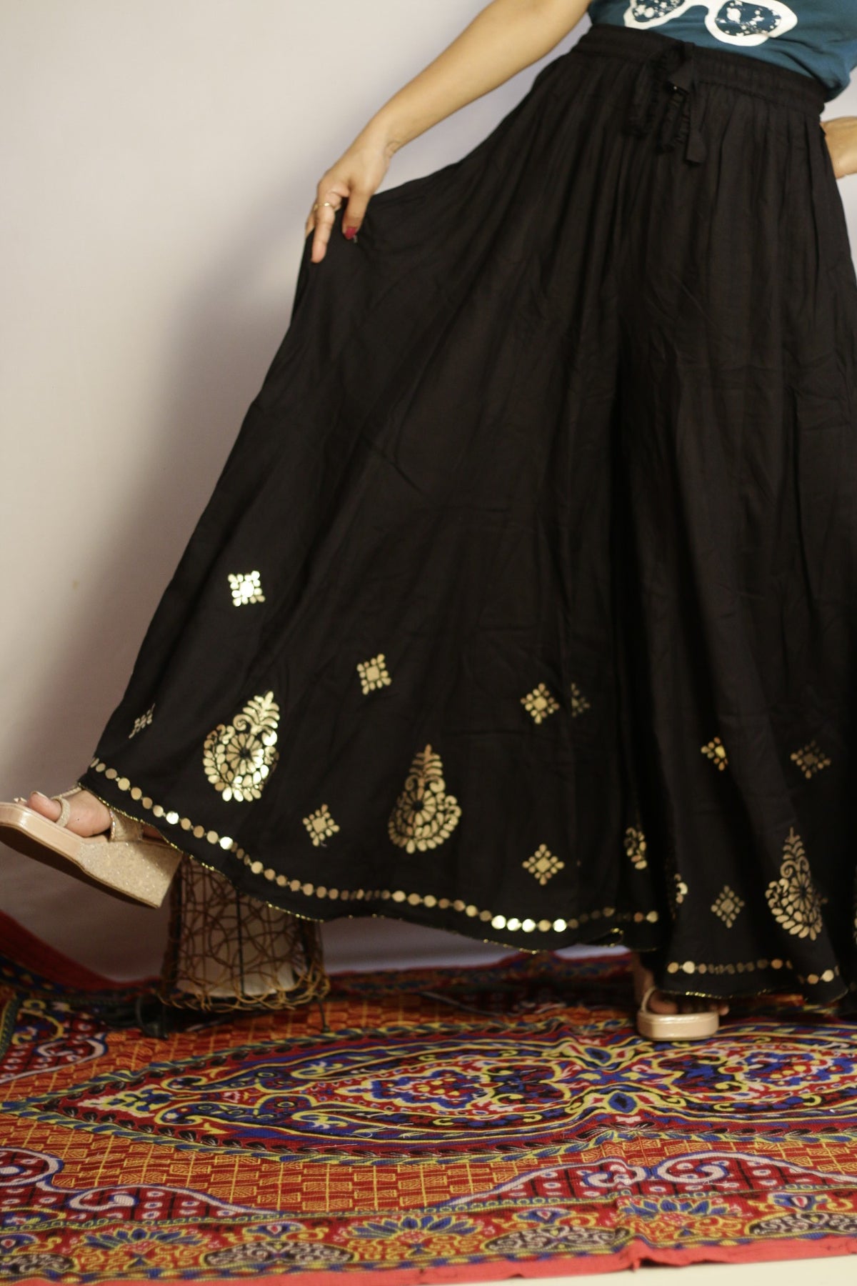Black gotta patti palazzo held open to show the full width of the flare