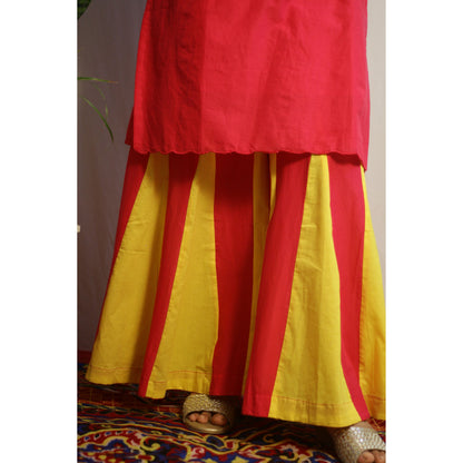 Red and yellow traditional outfit on a patterned rug
