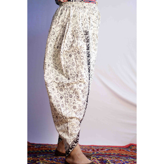 Floral-patterned harem pants on a plain background