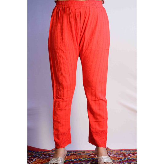 Red pants worn by a person on a plain background