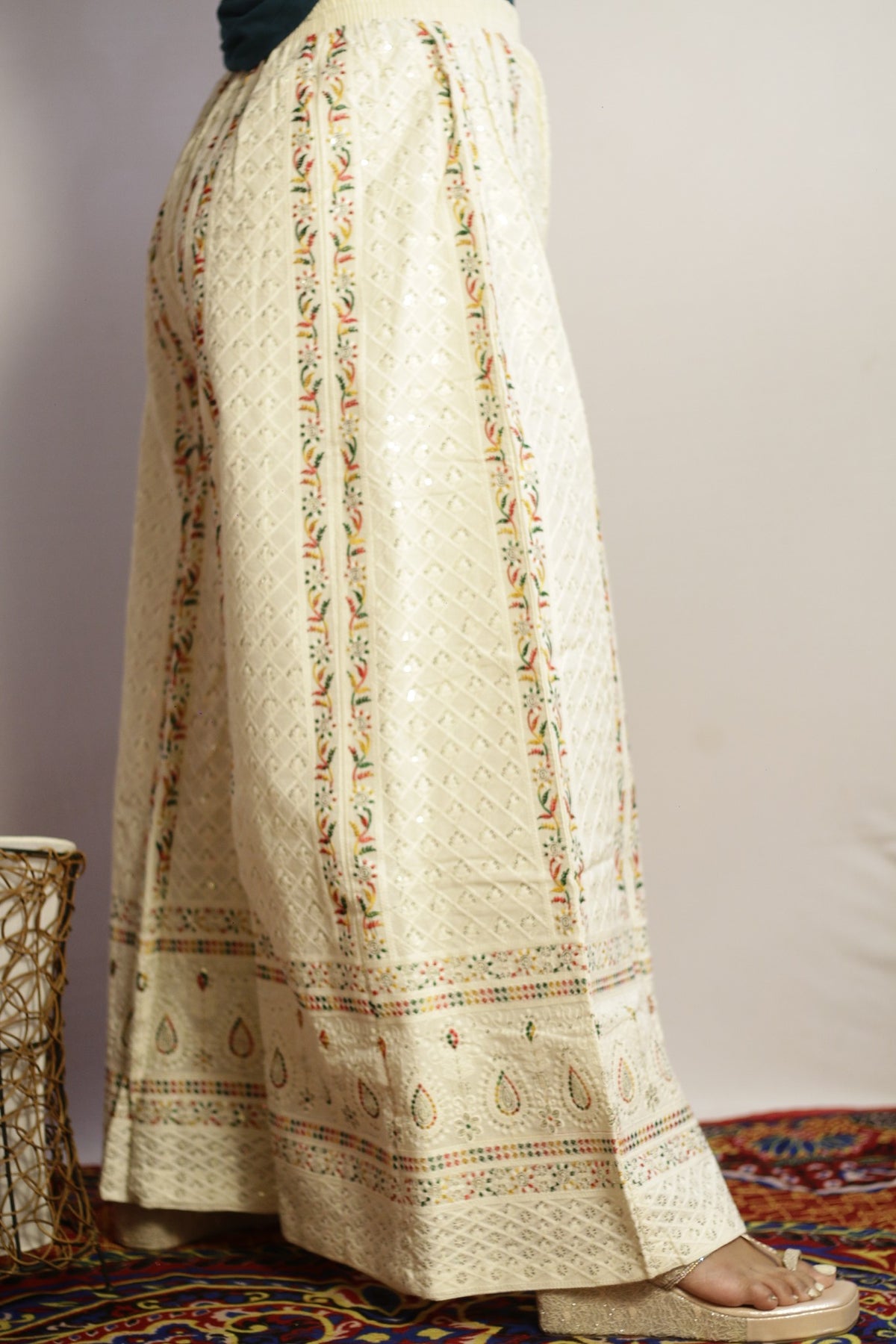 Beige embroidered palazzo side view showing the floral vine panels and sequin work