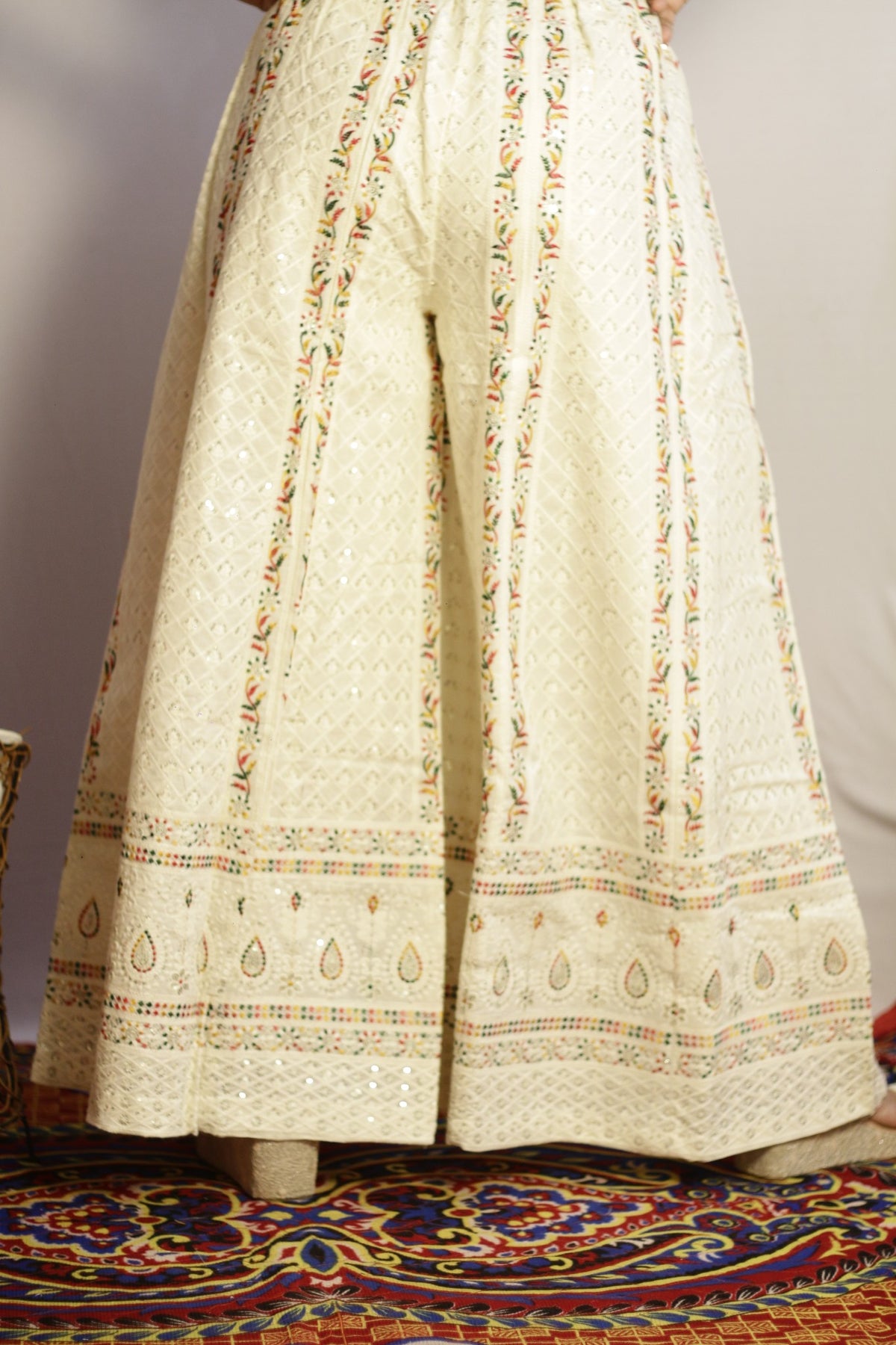 Back view of the beige embroidered cotton palazzo with elasticated gathered waist