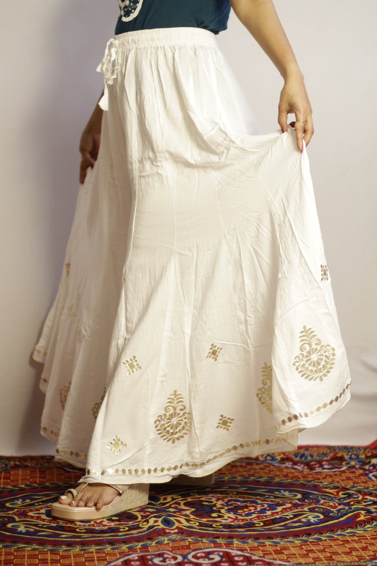 White rayon palazzo with gold gotta patti paisley motifs across the lower half