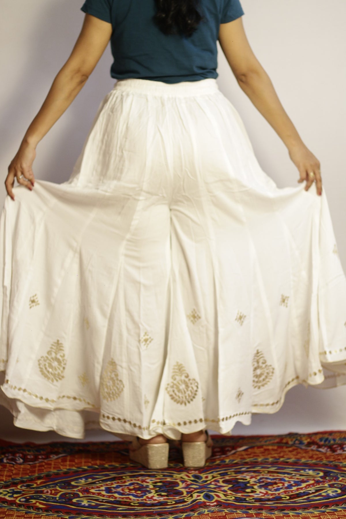 Back view of the white gotta patti palazzo showing the scalloped hem