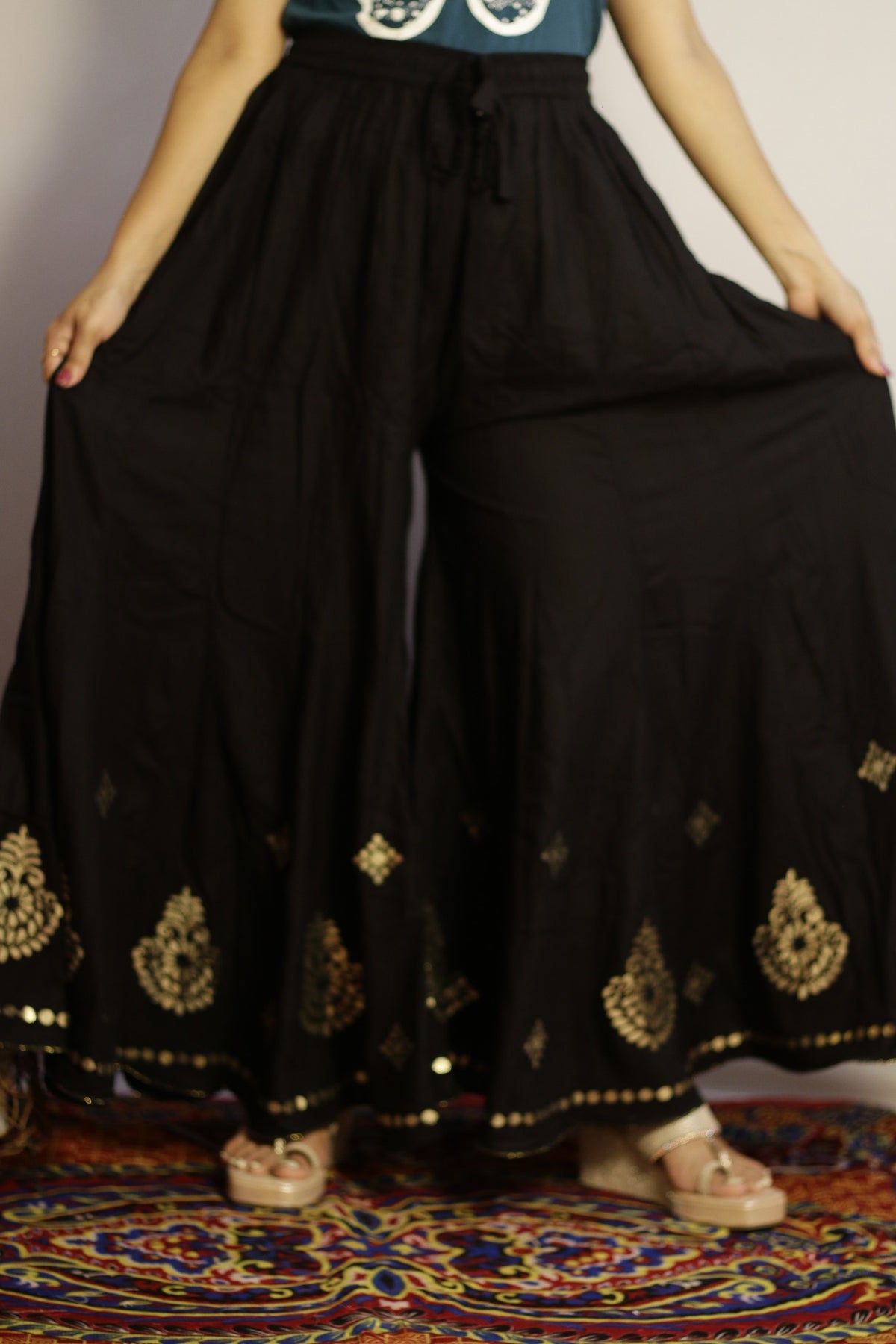 Black gotta patti palazzo in heavy rayon, front view with gold work and wide flare