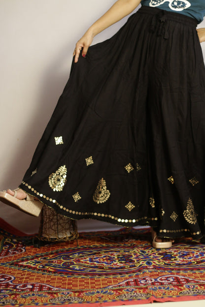 Black gotta patti palazzo held open to show the full width of the flare