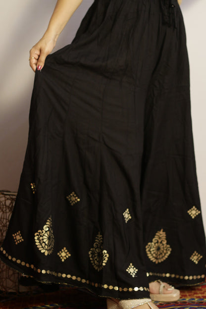 Black rayon palazzo side view showing the gold gotta patti work and drape