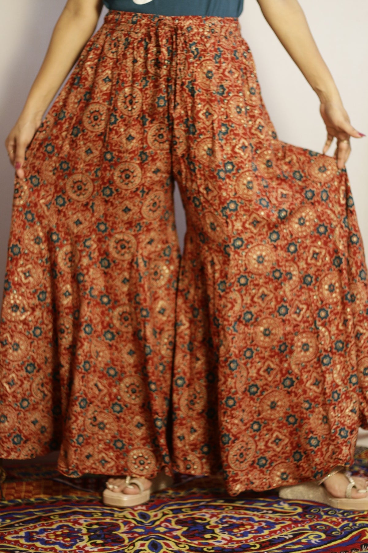 Rust kali palazzo in rayon, front view with ajrakh style print in teal and cream