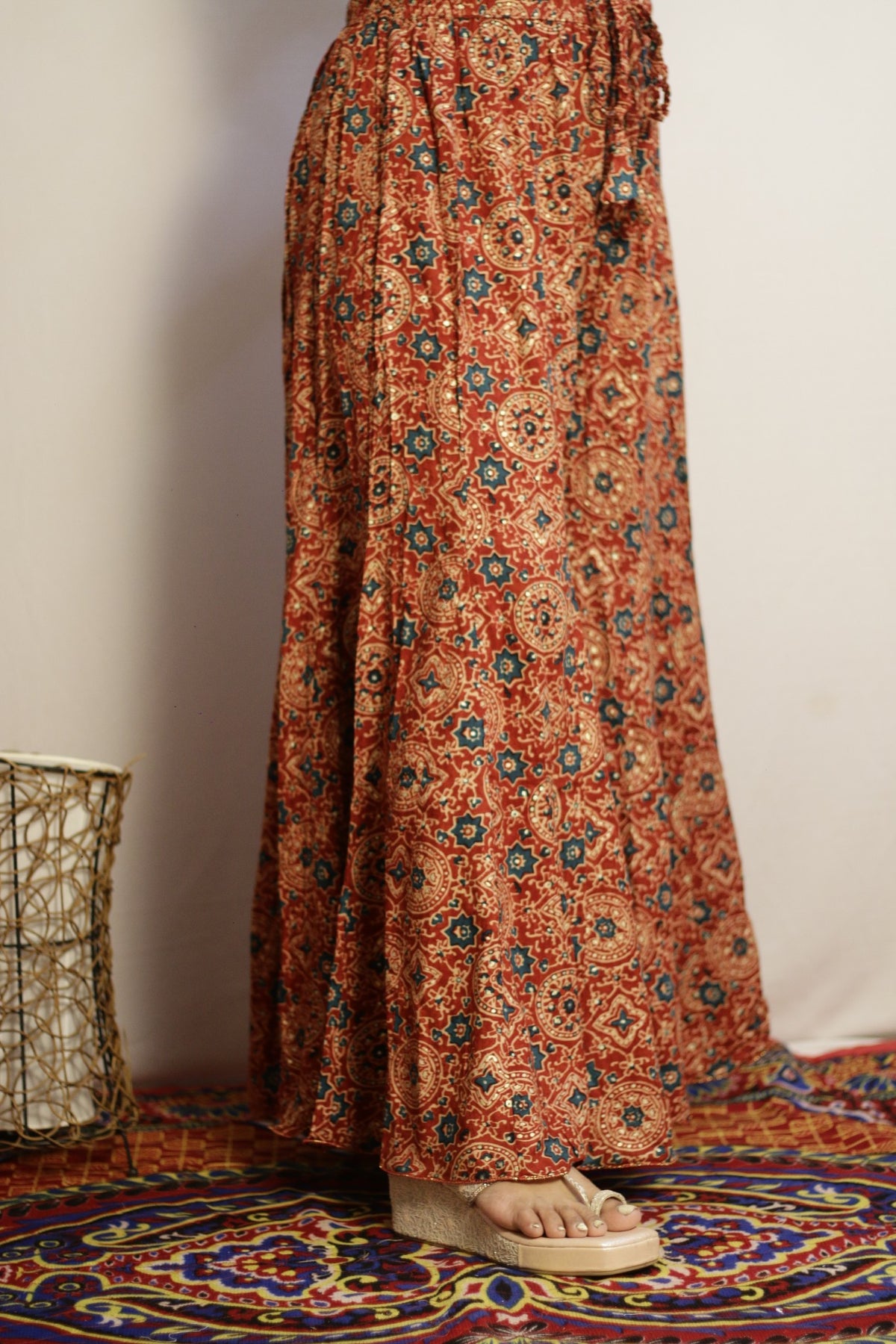 Rust printed palazzo side view showing the panelled kali flare