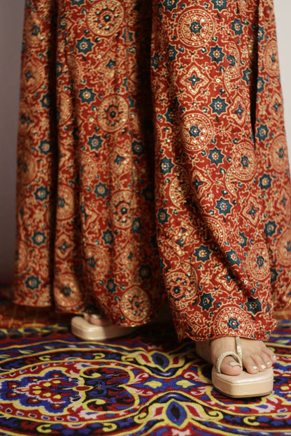 Close up of the ajrakh style print and sequin detail on the rust kali palazzo