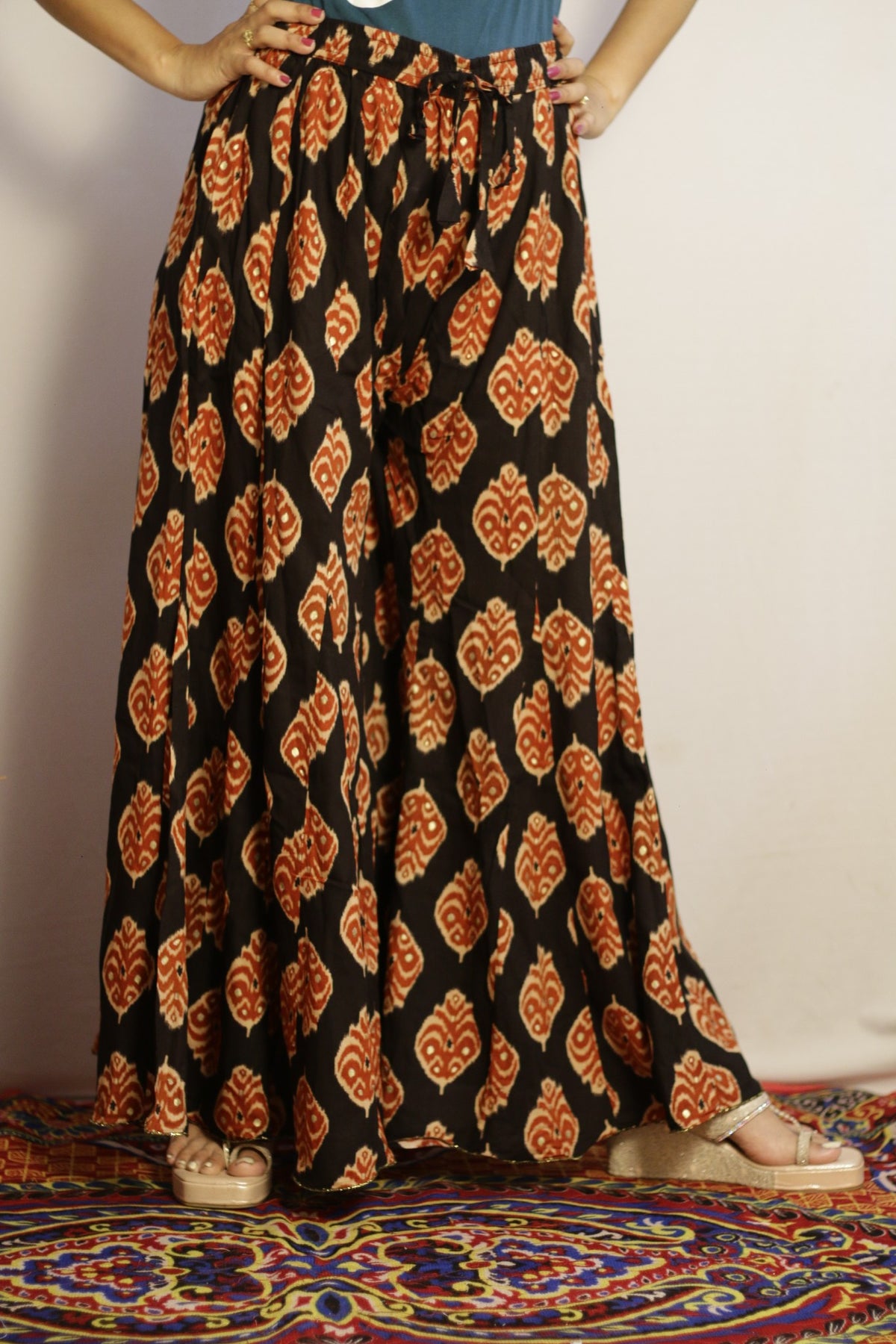 Black kali palazzo in rayon, front view with rust ikat print and sequin detail