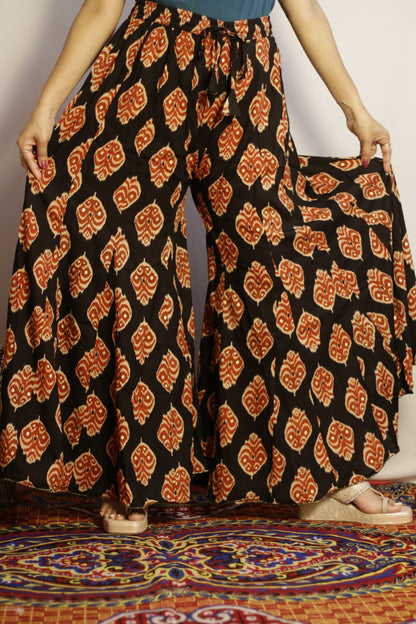 Black printed kali palazzo side view showing the panelled flare