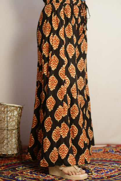 Black rayon palazzo with rust and cream ikat motifs and gold hem trim