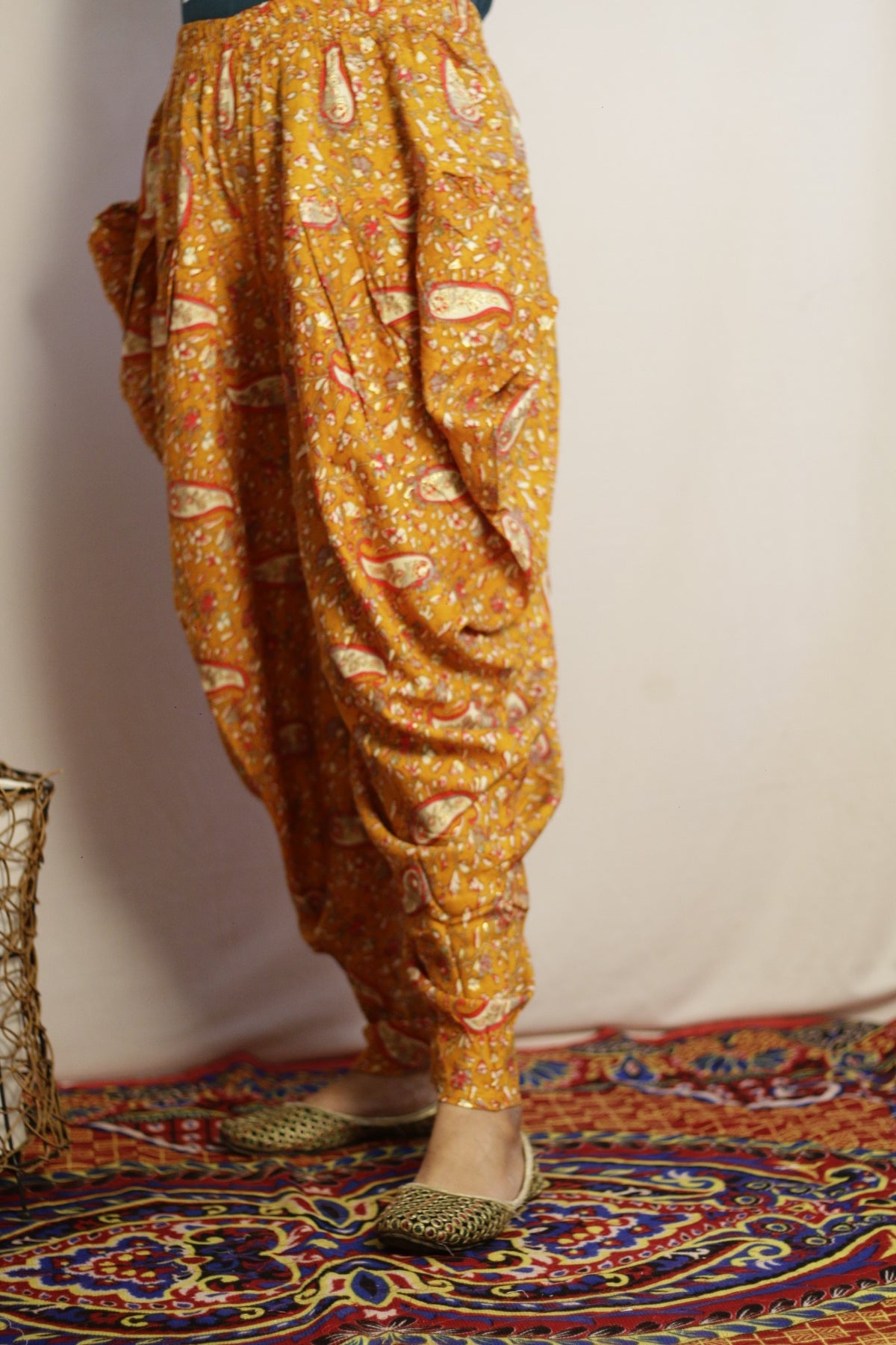 Mustard dhoti pant side view showing the deep drape at the hip