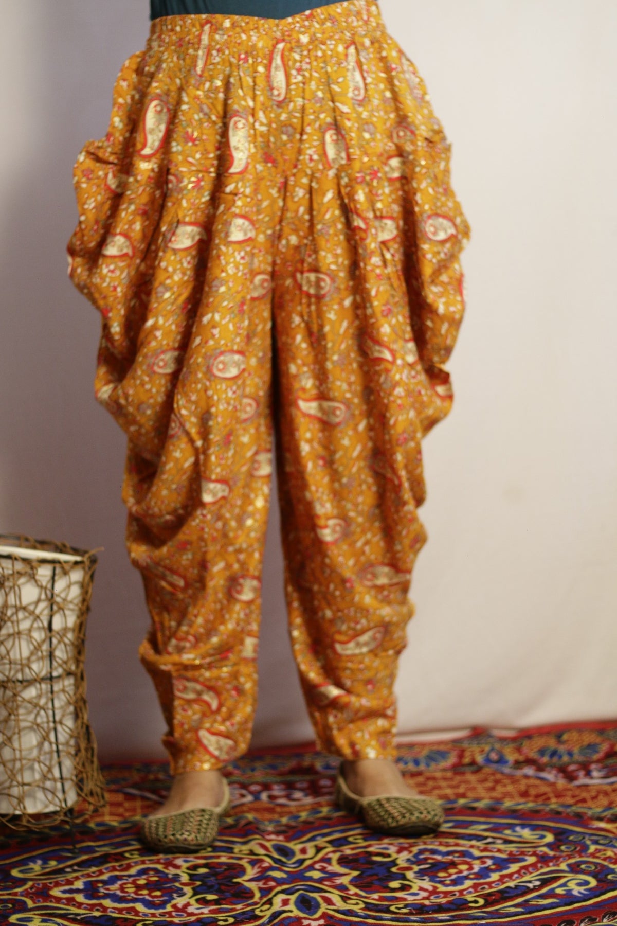 Mustard printed dhoti pant in rayon, front view with paisley print and draped pleats