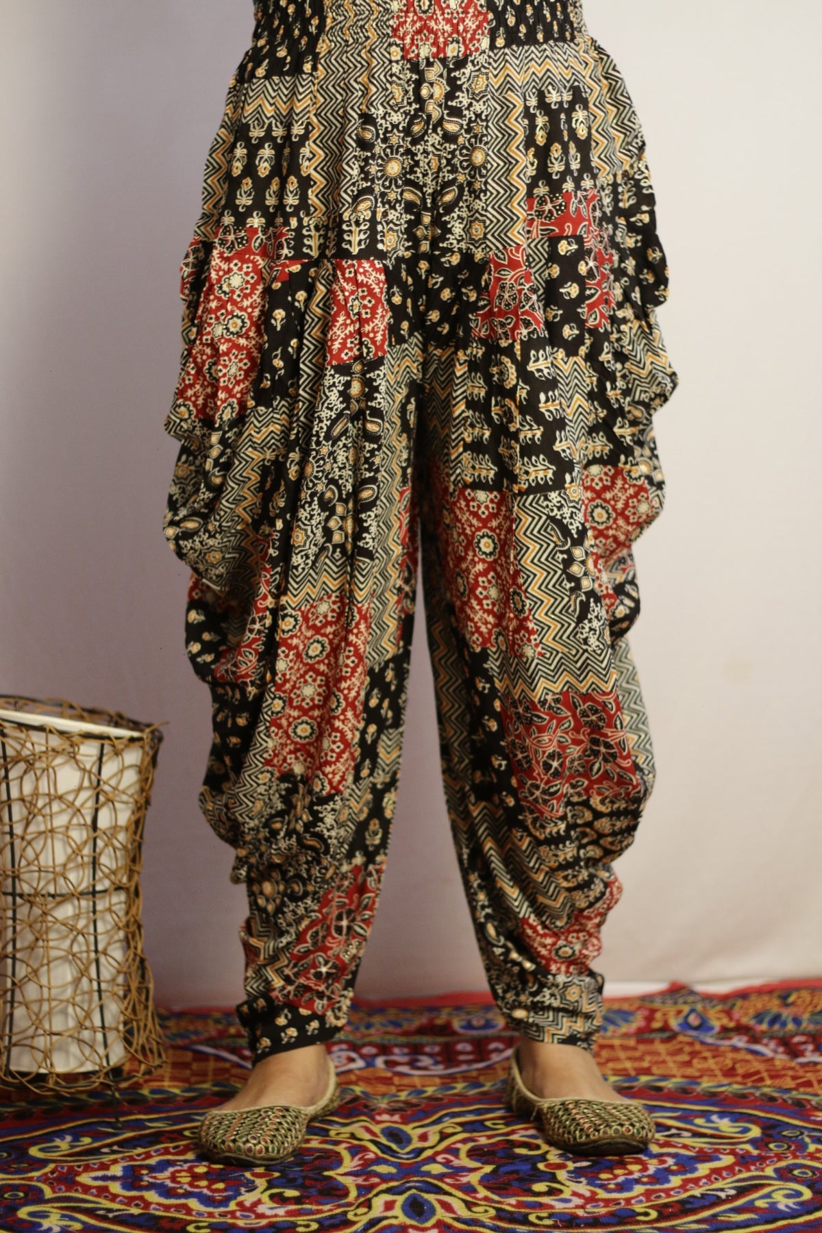 Black printed dhoti pant in rayon, front view with patchwork style print