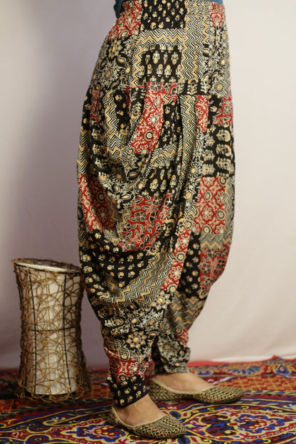 Black dhoti pant side view showing the draped folds at the hip