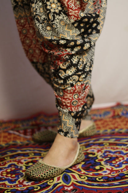 Close up of the tapered ankle and chevron patchwork print on the black dhoti