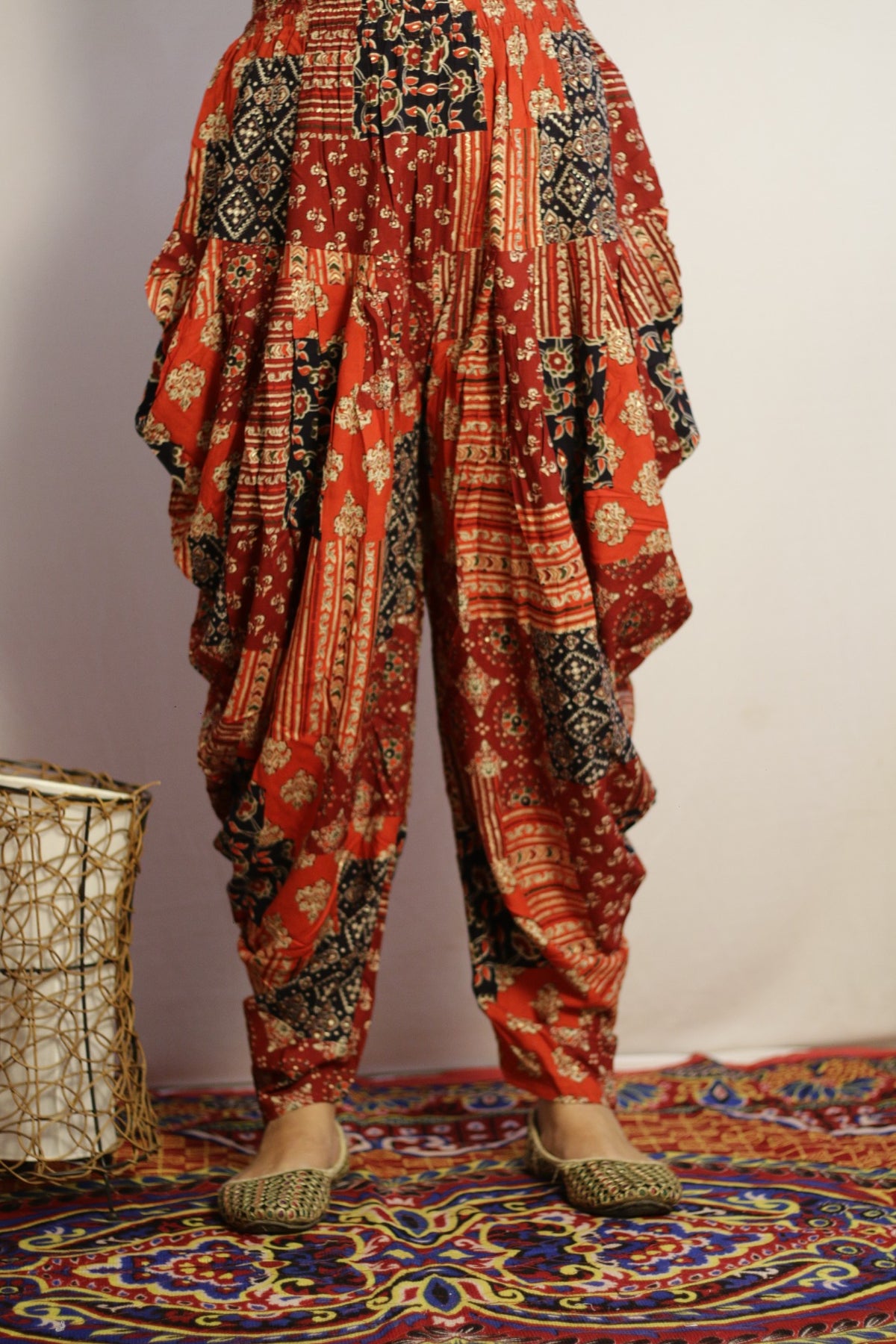 Red printed dhoti pant in rayon, front view with ajrakh style patchwork print