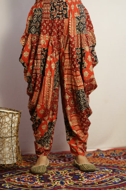 Red printed dhoti pant in rayon, front view with ajrakh style patchwork print