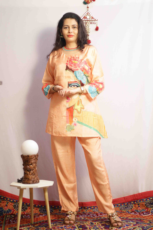 Woman wearing a traditional outfit with colorful embroidery in a decorated room.